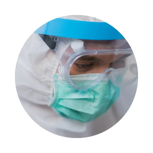 Healthcare worker wearing a face shield, mask and protective suit